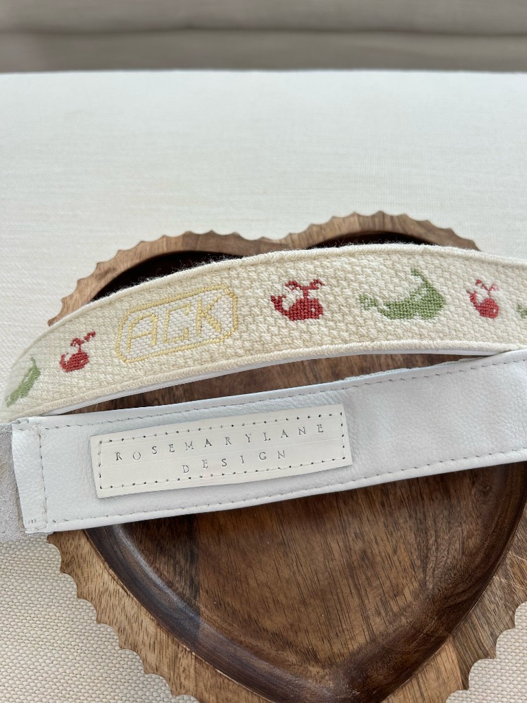 A custom needlepoint belt stitched with ACK, crabs, and whales